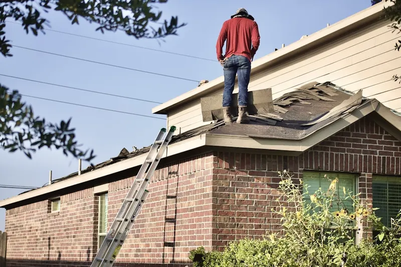 Professional roofer working on a residential roof in El Granada